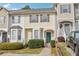 Charming townhome with a bright yellow facade, neat landscaping, and a welcoming green front door at 103 Timber Ridge Dr, Cartersville, GA 30121
