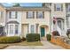 Charming townhome with a bright yellow facade, neat landscaping, and a welcoming green front door at 103 Timber Ridge Dr, Cartersville, GA 30121