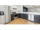 Modern kitchen with stainless steel appliances, contrasting dark and white cabinets, and wood-look flooring at 103 Timber Ridge Dr, Cartersville, GA 30121