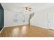 Open-concept living room with wood-look flooring and a view of the staircase at 103 Timber Ridge Dr, Cartersville, GA 30121