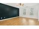 Large living room with sleek dark accent wall, hardwood floors, and natural light at 103 Timber Ridge Dr, Cartersville, GA 30121