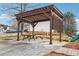 Community pergola covered picnic table and other play structures on a sunny day at 103 Timber Ridge Dr, Cartersville, GA 30121