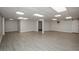 Spacious basement featuring wood-look floors, bright lighting, and ample room for various activities at 150 Karina Pl, Canton, GA 30115