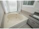 Neutral bathroom featuring a corner soaking tub and tile floors at 150 Karina Pl, Canton, GA 30115