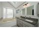 Bright bathroom featuring a soaking tub, double sink vanity with granite counters, and neutral colors at 150 Karina Pl, Canton, GA 30115