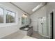 Bright bathroom with a double sink vanity, glass shower, and vaulted ceilings at 150 Karina Pl, Canton, GA 30115