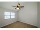 Neutral carpeted bedroom with a ceiling fan and bright window for a calm and inviting space at 150 Karina Pl, Canton, GA 30115