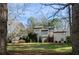 Exterior showcasing a multi-car garage, large front lawn, and well-maintained landscaping around a traditionally designed home at 150 Karina Pl, Canton, GA 30115