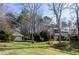 Home with a multi-car garage and attractive landscaping, with a well-manicured lawn and mature trees surrounding at 150 Karina Pl, Canton, GA 30115