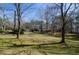 Large lawn area with mature trees scattered throughout, leading to the home and its well-kept surroundings at 150 Karina Pl, Canton, GA 30115