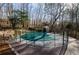 Backyard view featuring the covered swimming pool with a wooded surrounding at 150 Karina Pl, Canton, GA 30115
