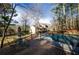 Outdoor pool with a security fence alongside a wooden deck and lush surrounding trees and a backyard at 150 Karina Pl, Canton, GA 30115
