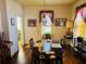 A dining room has wood flooring, a window, and a light fixture at 1948 Mercer Ave, College Park, GA 30337