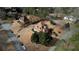 Expansive aerial view of a multi-story home, showcasing its architectural design and landscaped surroundings in a neighborhood setting at 5770 Wyndemere Ln, Stone Mountain, GA 30087