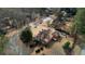 Aerial view of a landscaped home, showing its layout, back deck, and surrounding greenery in a residential neighborhood at 5770 Wyndemere Ln, Stone Mountain, GA 30087