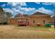 Spacious brick home featuring a wooden deck and a large, well-maintained yard at 5770 Wyndemere Ln, Stone Mountain, GA 30087