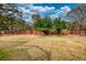 Expansive backyard, partially fenced and featuring mature trees, offers privacy and space at 5770 Wyndemere Ln, Stone Mountain, GA 30087