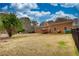 Expansive backyard featuring lush lawn, defined by wood and chain link fencing, and partial views of the home at 5770 Wyndemere Ln, Stone Mountain, GA 30087