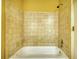 Cozy bathroom showcasing a standard white bathtub and neutral tiling around the shower walls at 5770 Wyndemere Ln, Stone Mountain, GA 30087