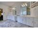 Bright bathroom featuring double vanity, white cabinets, modern tile flooring, glass shower at 5770 Wyndemere Ln, Stone Mountain, GA 30087