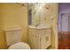 A half bathroom featuring a toilet, sink with vanity, mirror, and lighting fixture at 5770 Wyndemere Ln, Stone Mountain, GA 30087