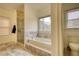 Large bathroom featuring glass shower, soaking tub, and modern tile flooring at 5770 Wyndemere Ln, Stone Mountain, GA 30087