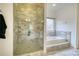 Bathroom featuring a glass enclosed tile shower and soaking tub with tile surround at 5770 Wyndemere Ln, Stone Mountain, GA 30087
