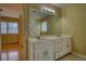 Bathroom showcasing a double vanity, granite countertop, storage cabinets, and a large mirror at 5770 Wyndemere Ln, Stone Mountain, GA 30087