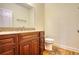 Elegant half bath with a granite countertop, wood cabinet, and wood floors at 5770 Wyndemere Ln, Stone Mountain, GA 30087