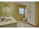 Bathroom featuring double sinks, neutral granite countertops, white cabinetry, and a toilet at 5770 Wyndemere Ln, Stone Mountain, GA 30087
