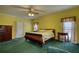 Bedroom featuring bright yellow walls, green carpet, wood dresser and bedside tables at 5770 Wyndemere Ln, Stone Mountain, GA 30087