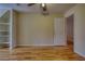 A bedroom features a closet, built-in shelves, hardwood floors, and a ceiling fan at 5770 Wyndemere Ln, Stone Mountain, GA 30087