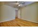 A spacious bedroom boasts hardwood floors, neutral walls, built-in shelves, and a ceiling fan at 5770 Wyndemere Ln, Stone Mountain, GA 30087