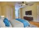 A bedroom features a bed, closet, TV, and hardwood floors at 5770 Wyndemere Ln, Stone Mountain, GA 30087