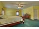 Bedroom featuring bright yellow walls, green carpet, and a wood dresser at 5770 Wyndemere Ln, Stone Mountain, GA 30087