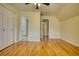Spacious bedroom featuring hardwood floors, an adjoining bathroom and a large closet at 5770 Wyndemere Ln, Stone Mountain, GA 30087