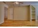 A spacious bedroom boasts hardwood floors, neutral walls, built-in shelves, and a ceiling fan at 5770 Wyndemere Ln, Stone Mountain, GA 30087