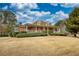 Charming exterior of a brick home featuring a welcoming front porch, landscaped front yard, and classic architectural details at 5770 Wyndemere Ln, Stone Mountain, GA 30087