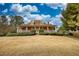 Inviting facade of a well-maintained home with a spacious front porch, set against a clear sky and landscaped lawn at 5770 Wyndemere Ln, Stone Mountain, GA 30087