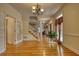 View of hallway featuring hardwood floors, staircase with white railing, and natural light from windows at 5770 Wyndemere Ln, Stone Mountain, GA 30087