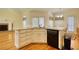 Corner kitchen featuring white cabinetry, modern appliances, and hardwood floors, with a breakfast nook at 5770 Wyndemere Ln, Stone Mountain, GA 30087