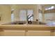 Close-up of a kitchen sink with modern faucet and white cabinetry, with a view to the breakfast nook at 5770 Wyndemere Ln, Stone Mountain, GA 30087