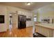 Bright kitchen features hardwood floors, white cabinets, and a view of the fireplace at 5770 Wyndemere Ln, Stone Mountain, GA 30087