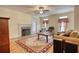 Cozy living room featuring a fireplace, hardwood floors, and comfortable seating area with a patterned rug at 5770 Wyndemere Ln, Stone Mountain, GA 30087
