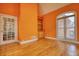 Bright living room featuring hardwood floors, arched window, and built in shelving at 5770 Wyndemere Ln, Stone Mountain, GA 30087
