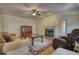 Living room with a fireplace, hardwood floors, and leather furniture in a traditionally styled home at 5770 Wyndemere Ln, Stone Mountain, GA 30087