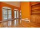 Bright living room featuring hardwood floors, natural light, a door to the patio, and built in shelving at 5770 Wyndemere Ln, Stone Mountain, GA 30087