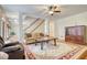 Spacious living room with hardwood floors, a staircase, and a comfortable seating area with a patterned rug at 5770 Wyndemere Ln, Stone Mountain, GA 30087