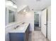 Bathroom with double vanity, marble countertop, tile floor, and modern fixtures at 6296 Flamingo Way, Morrow, GA 30260