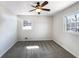 Bedroom featuring plush carpet, two windows, and a ceiling fan at 6296 Flamingo Way, Morrow, GA 30260